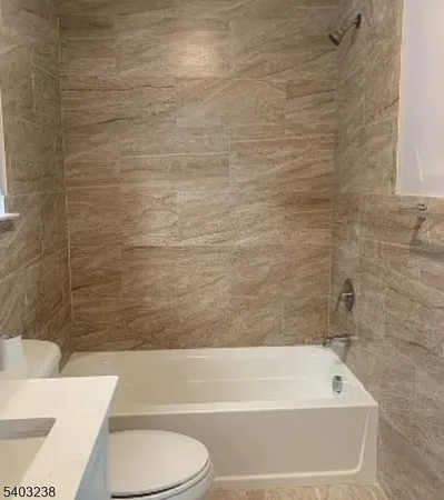 a bathroom with a bathtub and a toilet