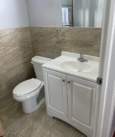 a bathroom with a sink toilet and mirror