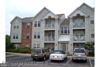693 Winding Stream Way, Unit 201 Odenton, MD 21113 - Photo 2 of 28 a car parked in front of a brick house