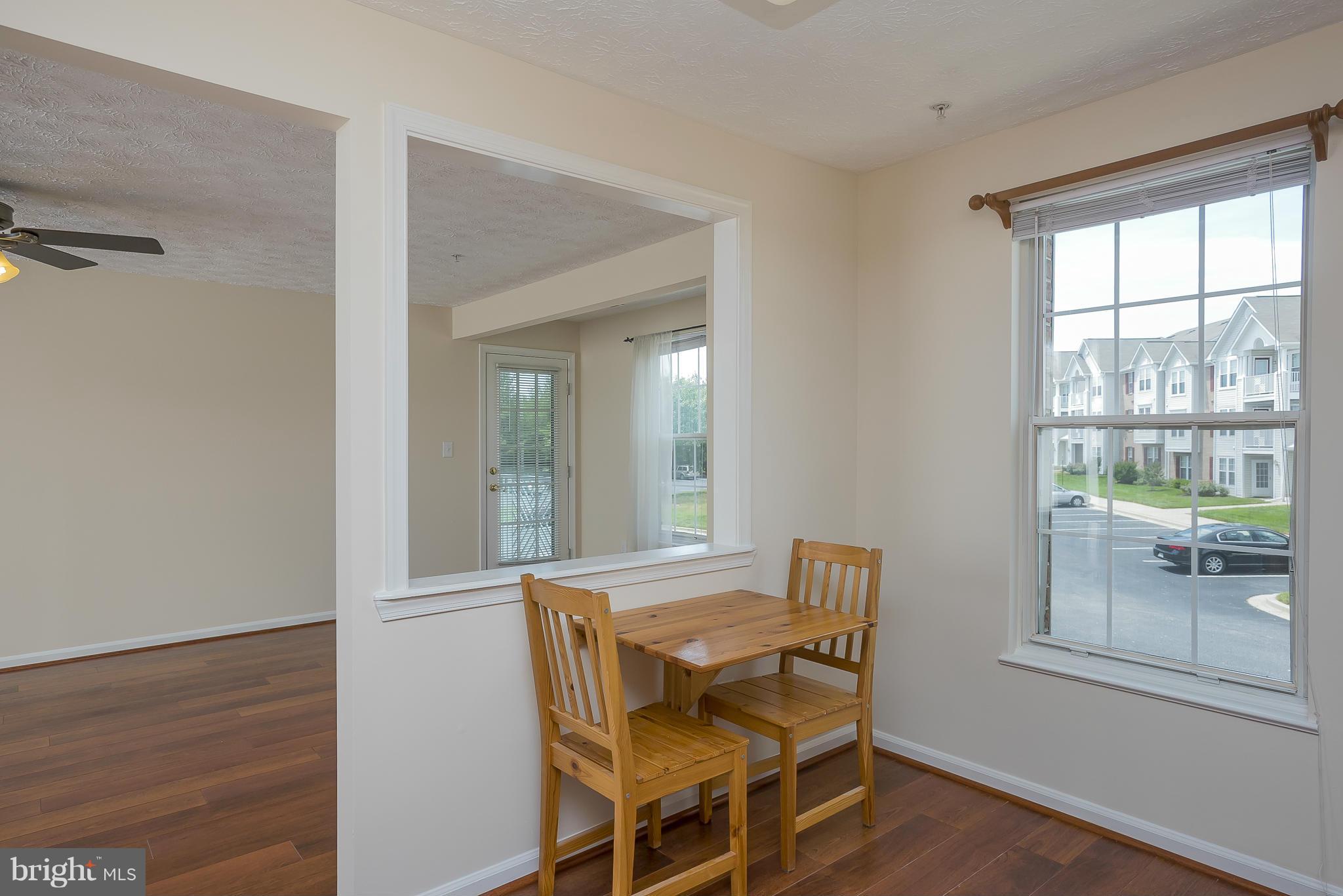 693 Winding Stream Way, Unit 201 Odenton, MD 21113 - Photo 6 of 28 a view of a dining room with furniture and window