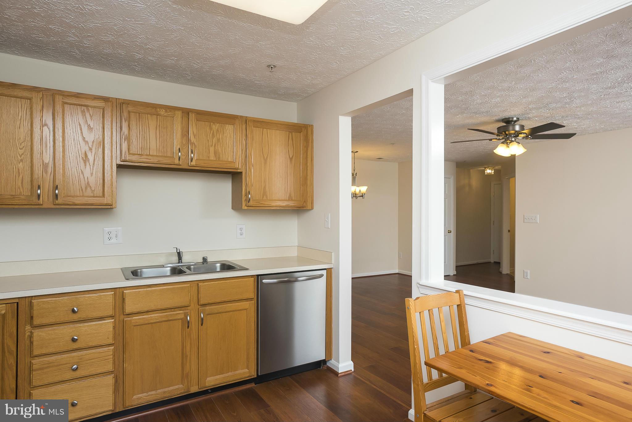 693 Winding Stream Way, Unit 201 Odenton, MD 21113 - Photo 8 of 28 a kitchen with a sink cabinets and wooden floor