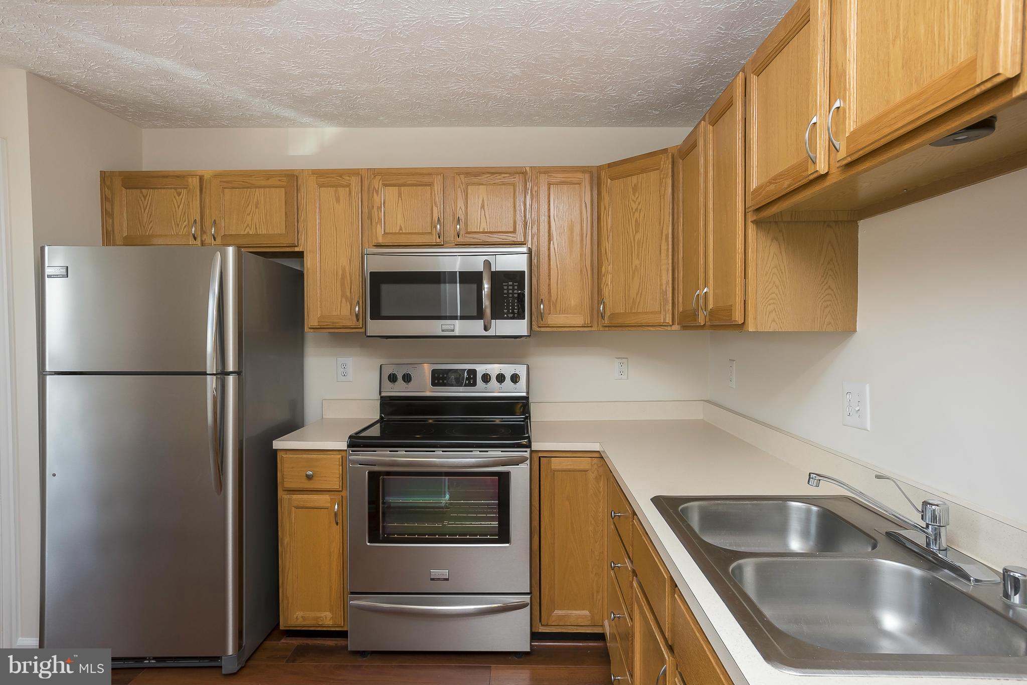 693 Winding Stream Way, Unit 201 Odenton, MD 21113 - Photo 10 of 28 a kitchen with a refrigerator sink and microwave