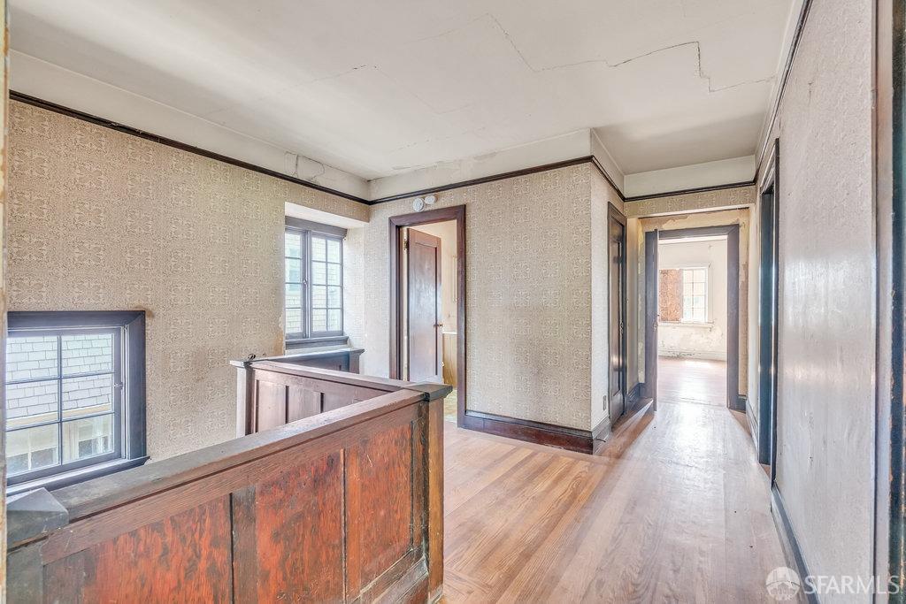 2815 Ashby Avenue Berkeley, CA 94705 - Photo 29 of 57 a view of a hallway with wooden floor and staircase