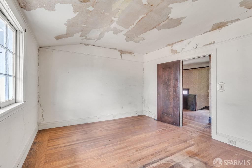 2815 Ashby Avenue Berkeley, CA 94705 - Photo 35 of 57 a view of a big room with wooden floor and windows