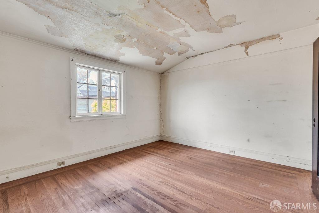 2815 Ashby Avenue Berkeley, CA 94705 - Photo 36 of 57 an empty room with wooden floor and windows