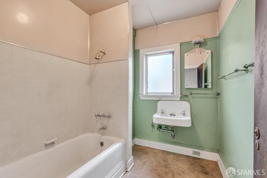 2815 Ashby Avenue Berkeley, CA 94705 - Photo 39 of 57 a bathroom with a bathtub sink and mirror