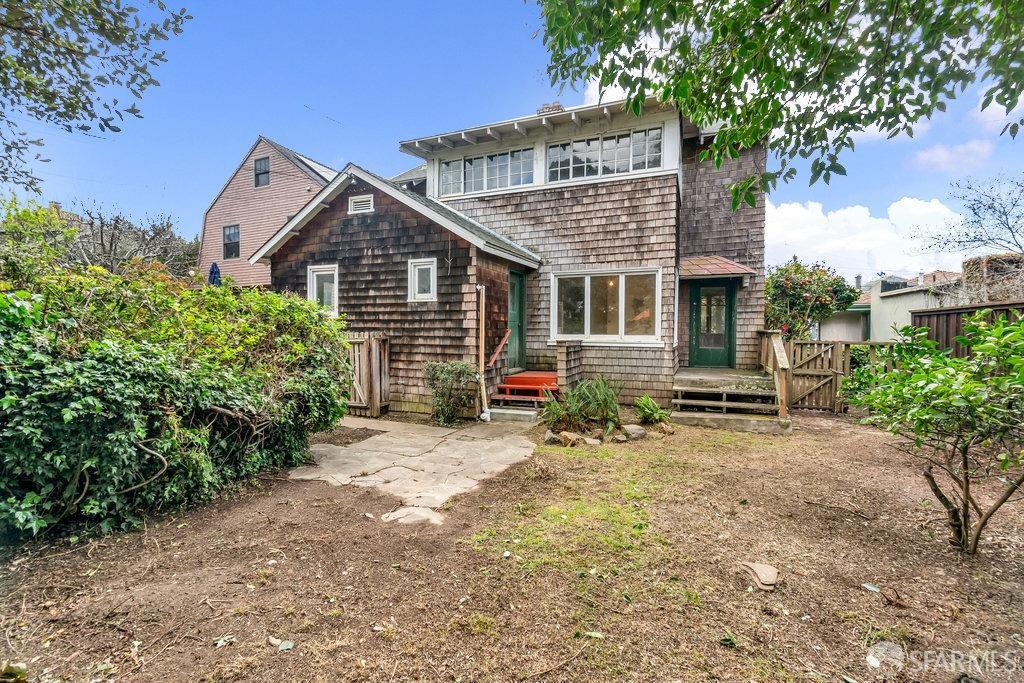 2815 Ashby Avenue Berkeley, CA 94705 - Photo 42 of 57 a view of a small house with a small yard and large trees