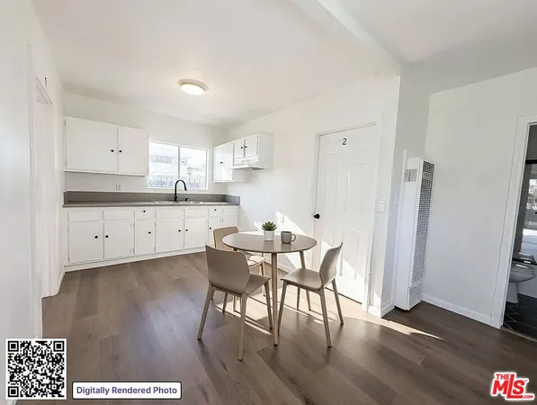 a kitchen with stainless steel appliances a dining table chairs a refrigerator and cabinets