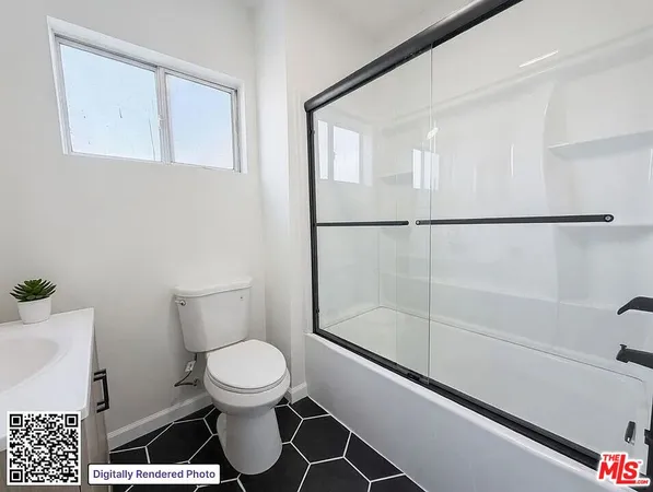 a bathroom with a toilet a sink and a shower