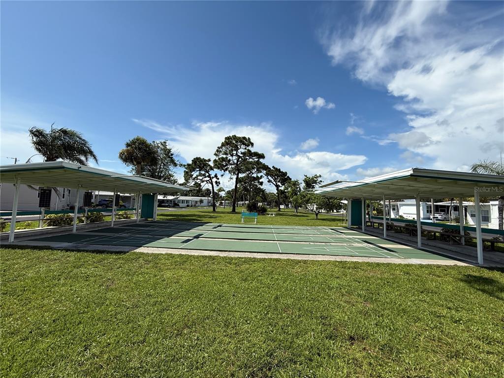 231 Inner Drive East Venice, FL 34285 - Photo 11 of 13 a view of a big house with a big yard and potted plants