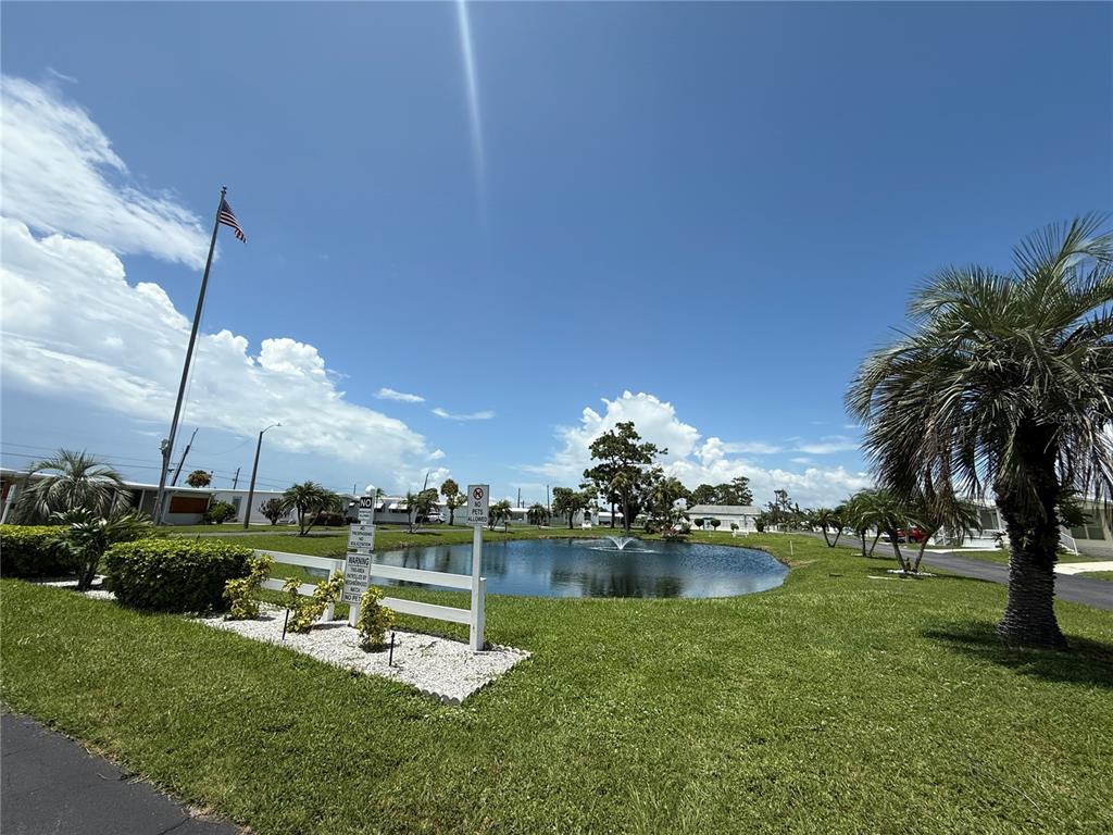 231 Inner Drive East Venice, FL 34285 - Photo 2 of 13 a view of a lake with a big yard