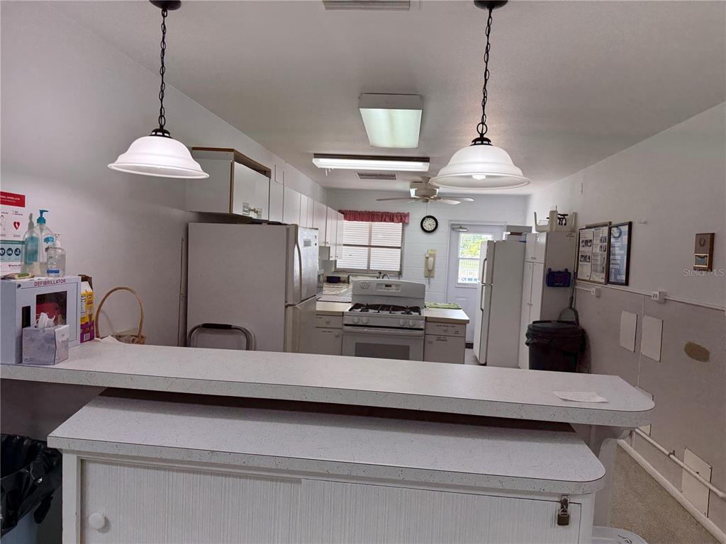 231 Inner Drive East Venice, FL 34285 - Photo 6 of 13 a kitchen with stainless steel appliances a counter a sink and a wooden floor