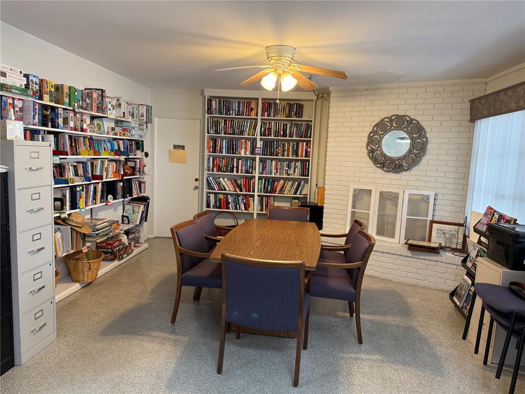 231 Inner Drive East Venice, FL 34285 - Photo 7 of 13 a dining room with furniture and a book shelf