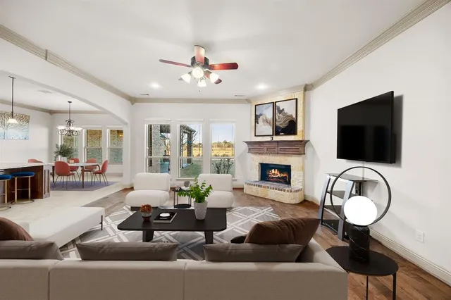 a living room with furniture a flat screen tv and a fireplace