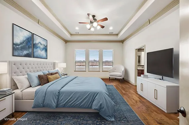 a spacious bedroom with a large bed and a flat screen tv