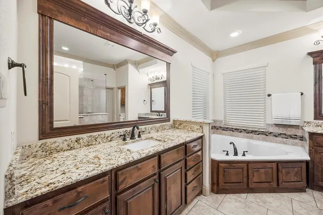 a bathroom with a granite countertop bathtub sink and mirror