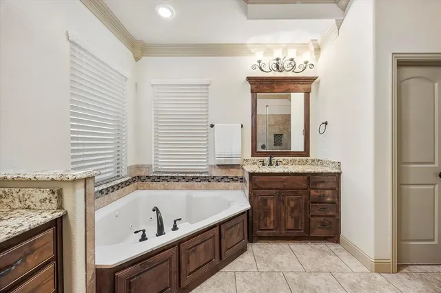 a bathroom with a tub sink and mirror