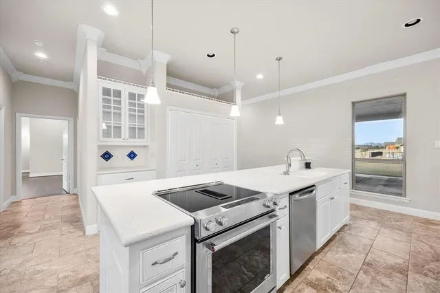 a kitchen that has a sink and a stove in it