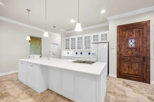 a kitchen with a sink and refrigerator