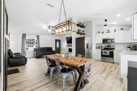 a view of a dining room with furniture and wooden floor