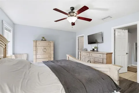 a bedroom with a bed and a flat screen tv