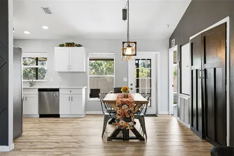 a view of a dining room with furniture window and wooden floor