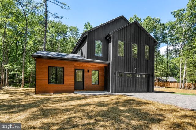 a view of a house with a wooden fence