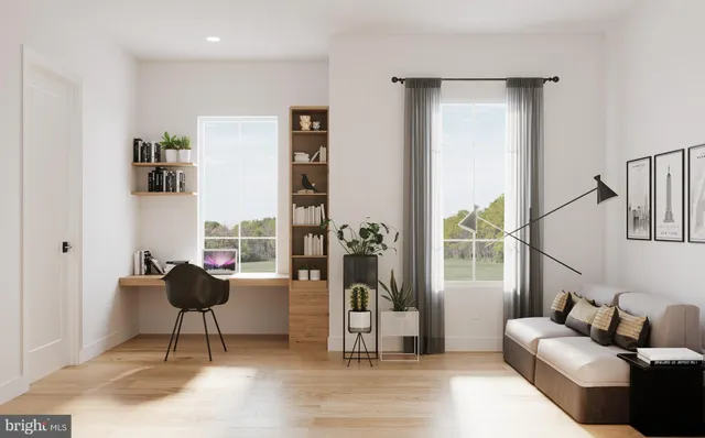 a living room with furniture and a potted plant