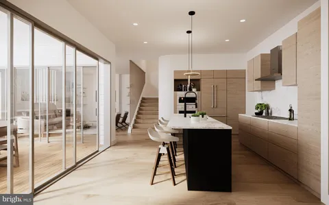 a kitchen with stainless steel appliances kitchen island granite countertop a refrigerator a stove and a sink with wooden floor