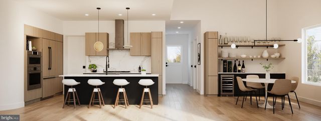 a kitchen with stainless steel appliances kitchen island granite countertop a table and chairs in it