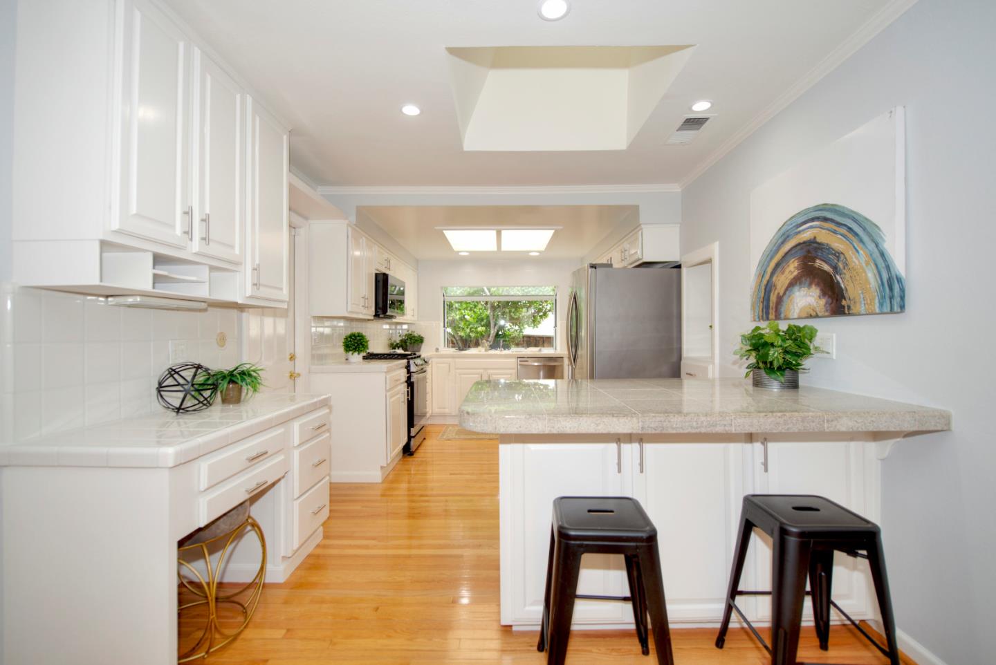 1396 Fallen Leaf Drive Milpitas, CA 95035 - Photo 14 of 43 a white kitchen with a sink and living room