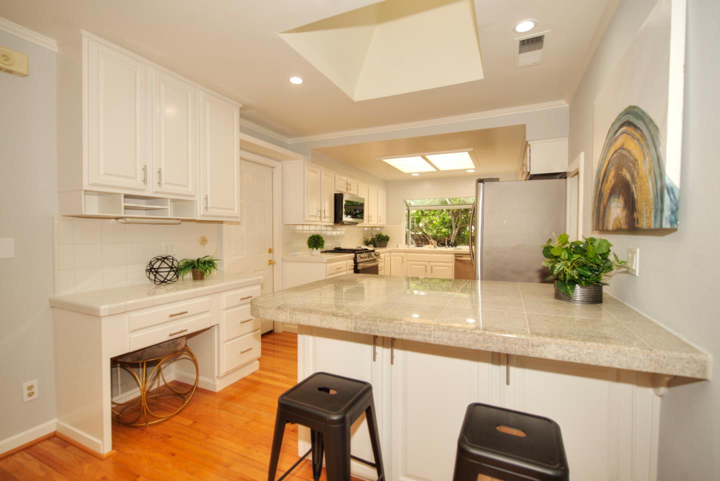 1396 Fallen Leaf Drive Milpitas, CA 95035 - Photo 15 of 43 a kitchen with kitchen island granite countertop a sink a stove and cabinets
