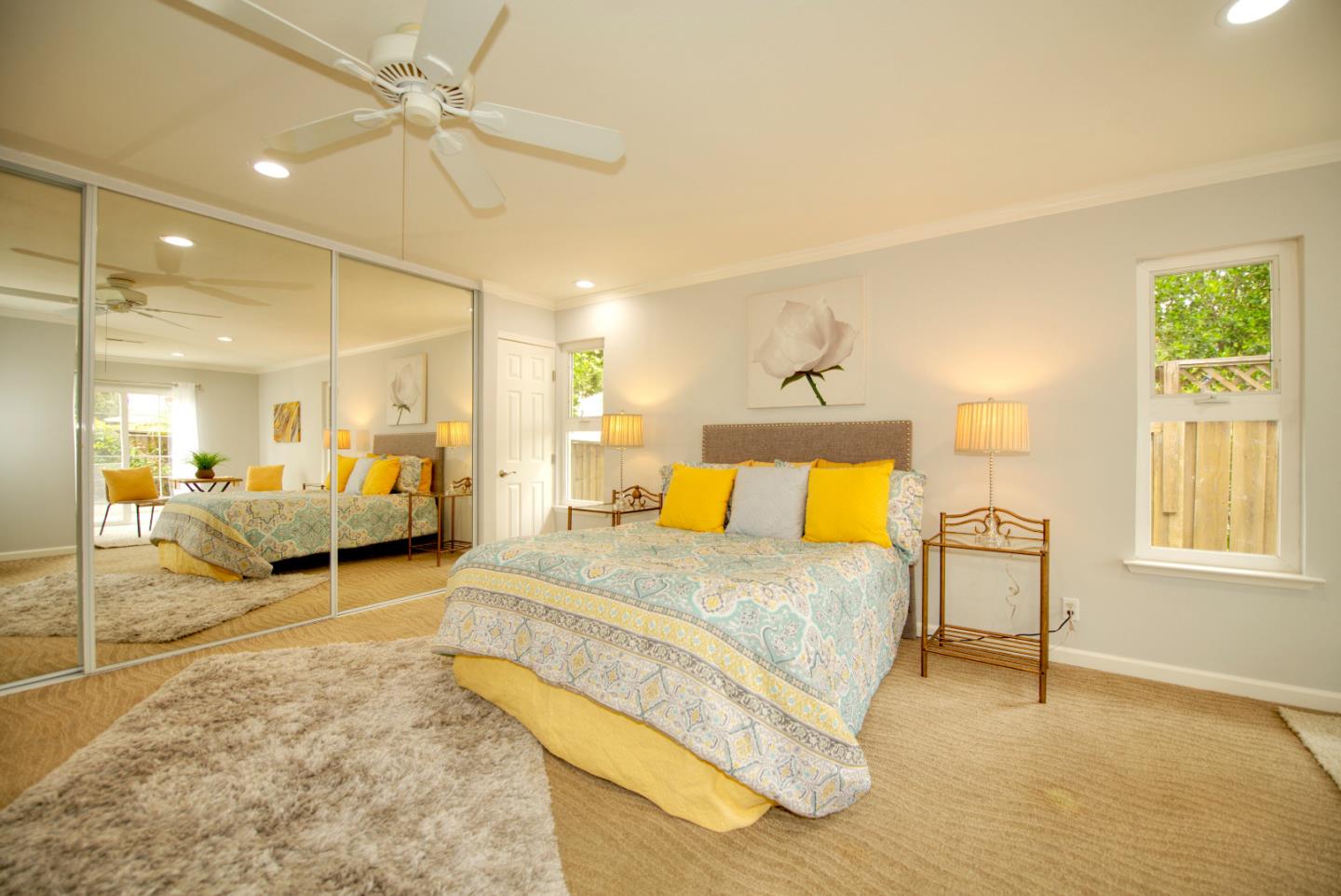 1396 Fallen Leaf Drive Milpitas, CA 95035 - Photo 18 of 43 a spacious bedroom with a bed a table and painting on the wall