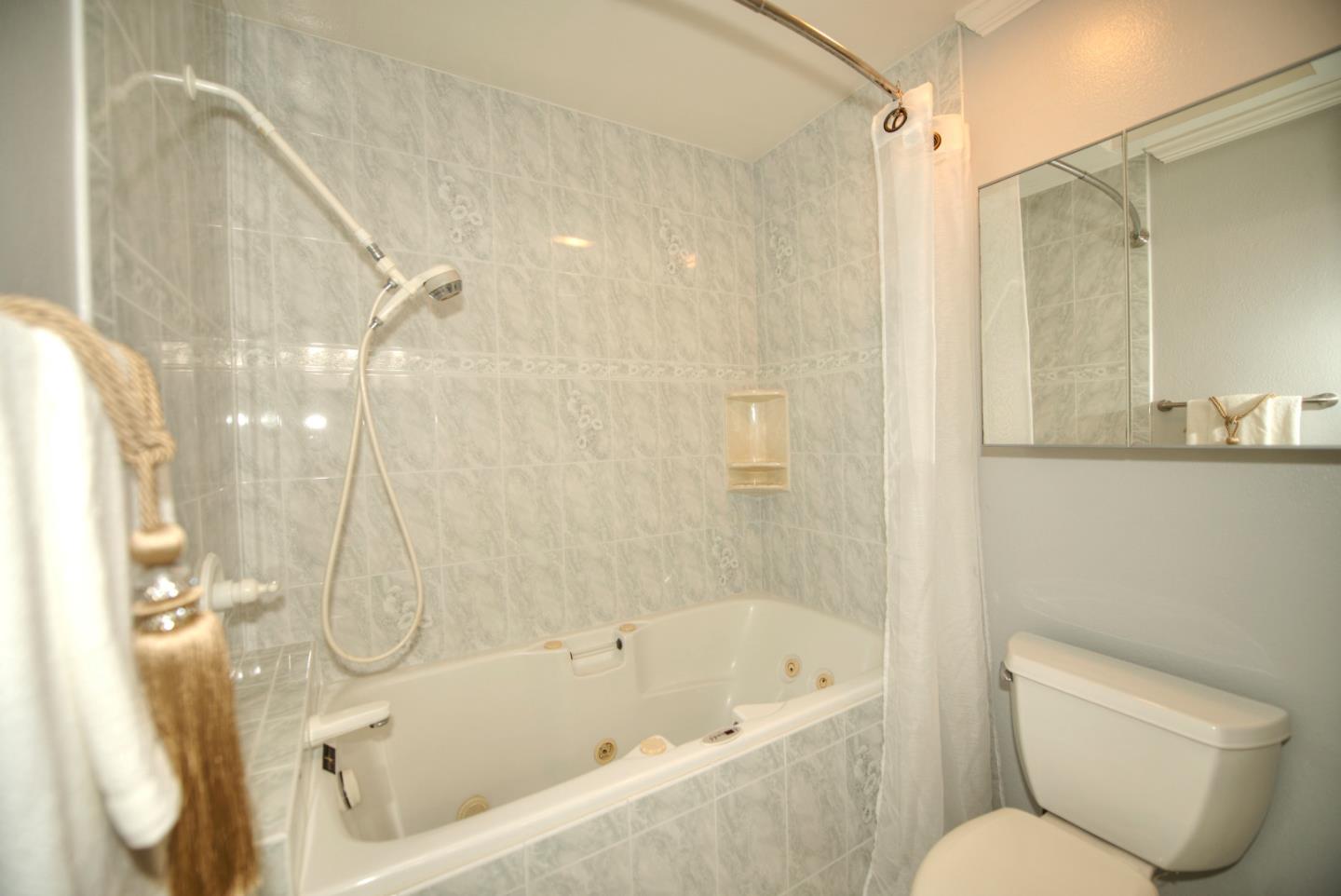 1396 Fallen Leaf Drive Milpitas, CA 95035 - Photo 24 of 43 a bathroom with a toilet and a bathtub