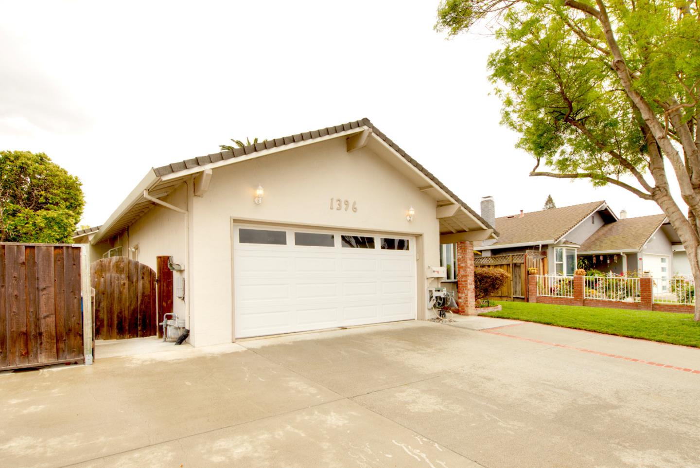 1396 Fallen Leaf Drive Milpitas, CA 95035 - Photo 41 of 43 a front view of a house with a yard and garage