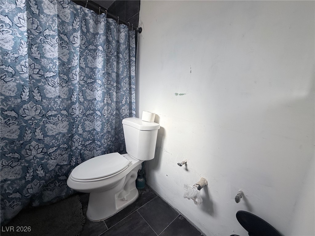 557 Chandler Street Henderson, NV 89014 - Photo 10 of 21 shower only, toilet, and missing bathroom vanity and sink, and faucet