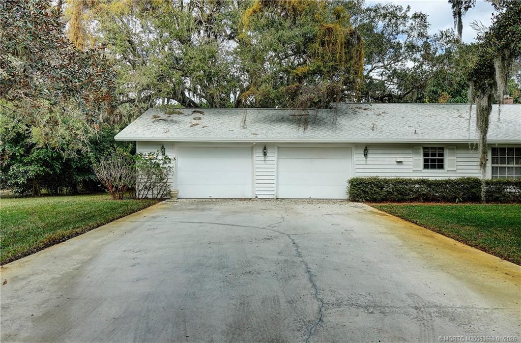4 Miramar Road Sewall's Point, FL 34996 - Photo 9 of 31 a front view of a house with a yard and garage