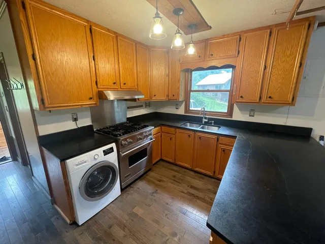 a kitchen with wooden cabinets and sink