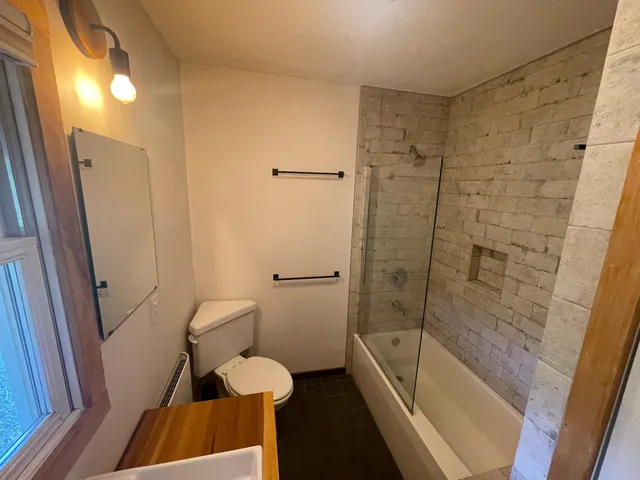 a bathroom with a tub and a shower