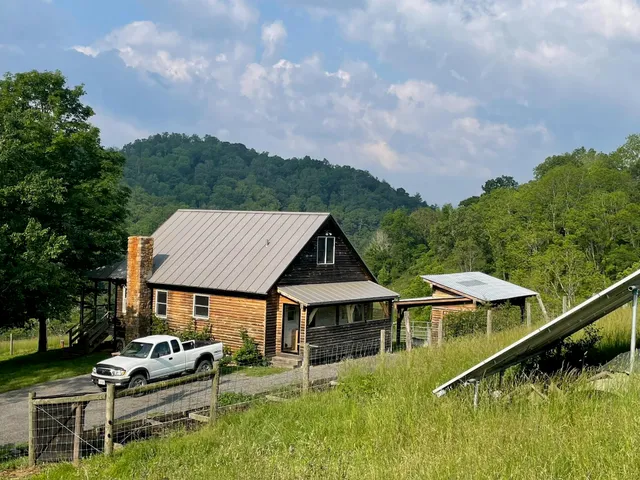 a aerial view of a house with swimming pool and mountains in the background