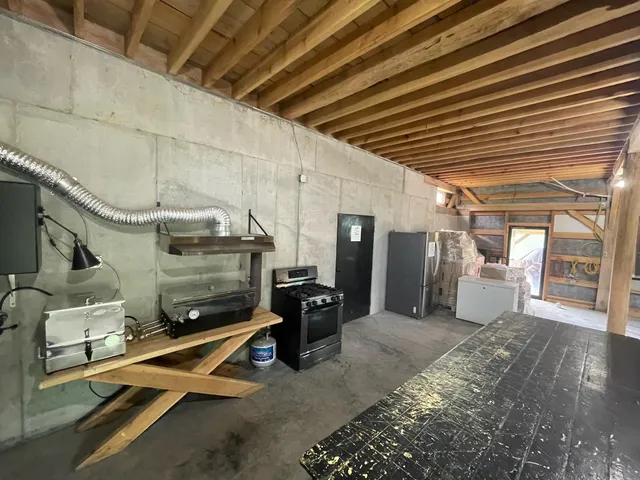 a view of a refrigerator in kitchen and utility room