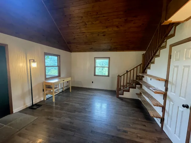 a view of entryway and hall with wooden floor