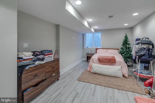 a bedroom with a bed and a potted plant