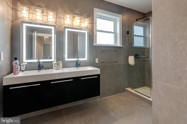 a bathroom with 2 sink and a mirror