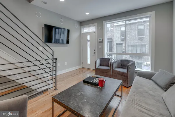 a living room with furniture and a flat screen tv