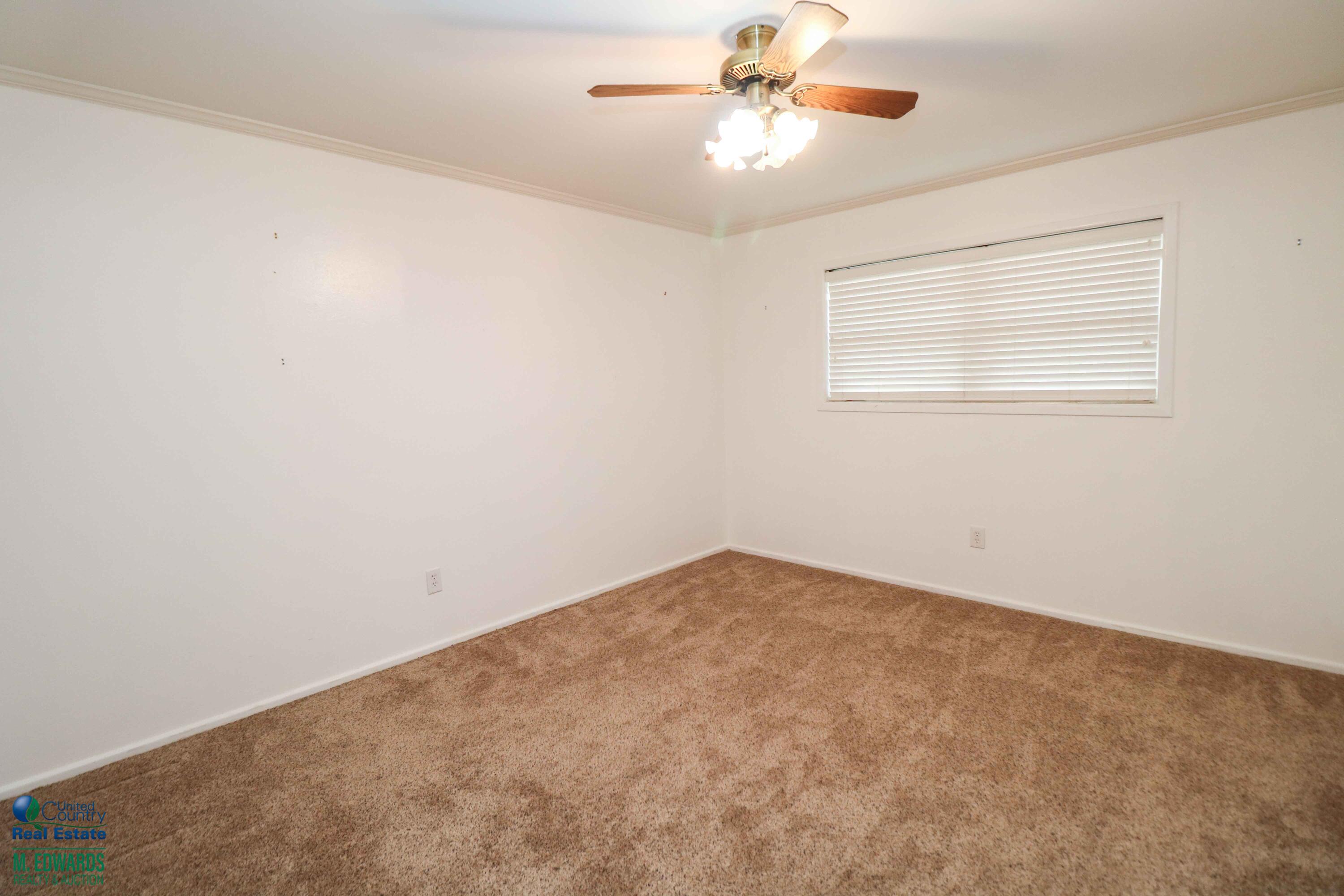 200 Crescent Drive Littlefield, TX 79339 - Photo 14 of 25 an empty room with windows and fan