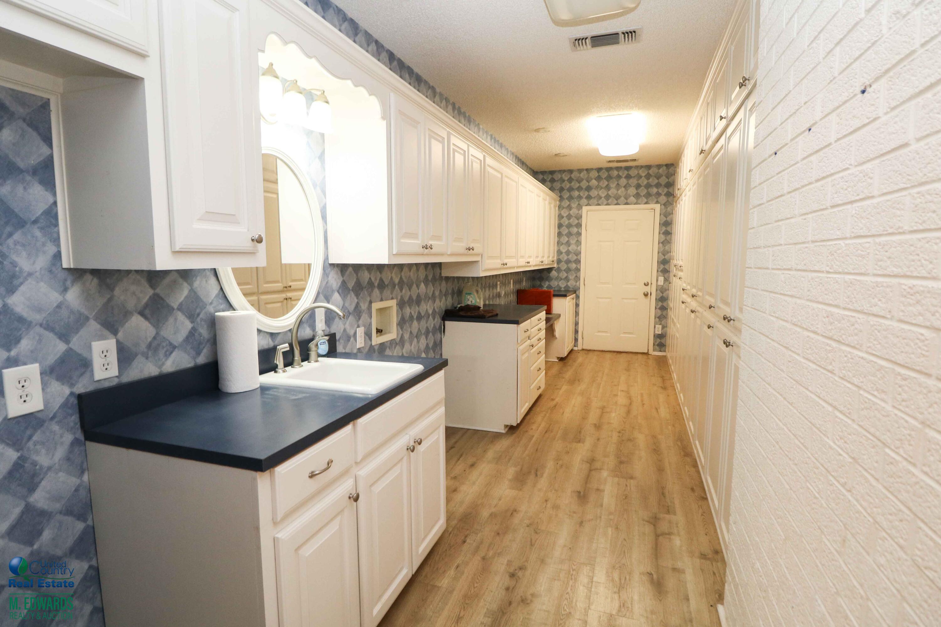 200 Crescent Drive Littlefield, TX 79339 - Photo 16 of 25 a kitchen with a sink a counter top space and appliances