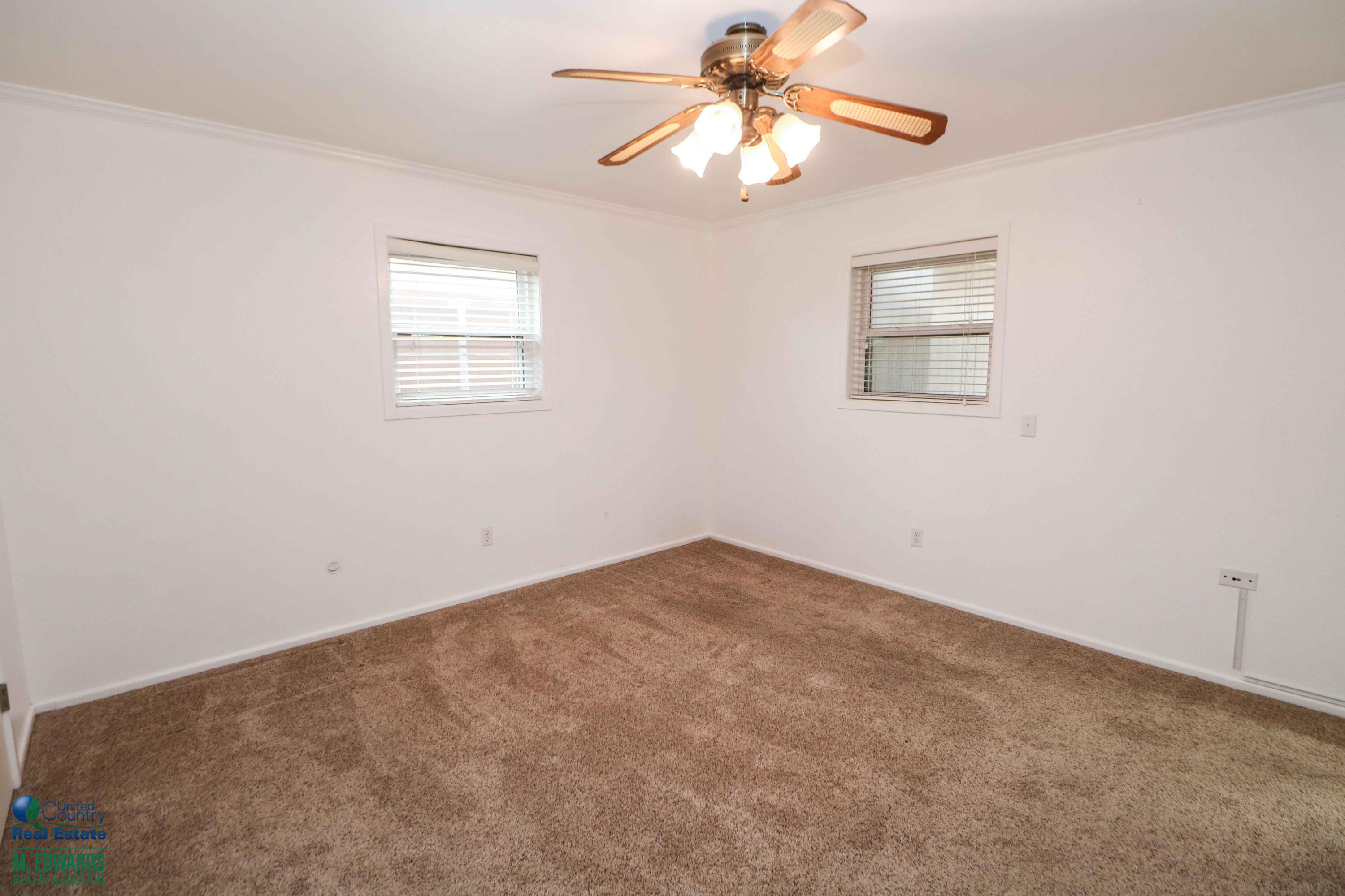200 Crescent Drive Littlefield, TX 79339 - Photo 17 of 25 an empty room with windows and fan