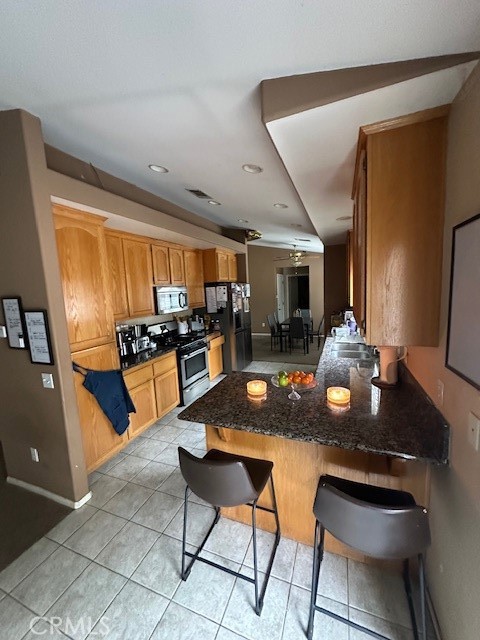 4485 Riverview Drive Riverside, CA 92509 - Photo 11 of 36 a kitchen with a dining table and chairs