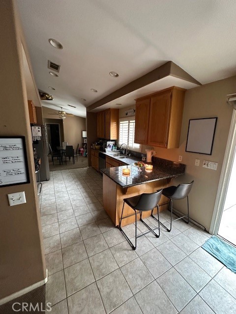4485 Riverview Drive Riverside, CA 92509 - Photo 12 of 36 a living room with furniture a flat screen tv and kitchen view